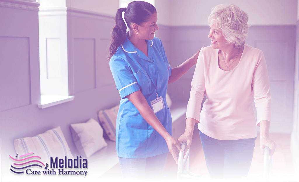 Hospice caregiver assisting elderly woman with walking